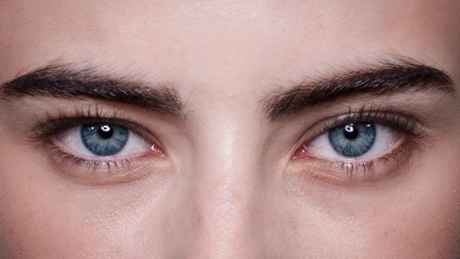 Close up of model with blue hooded eyes