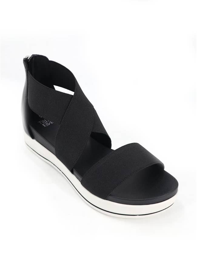 Black sandal with wide elastic straps and a white platform sole