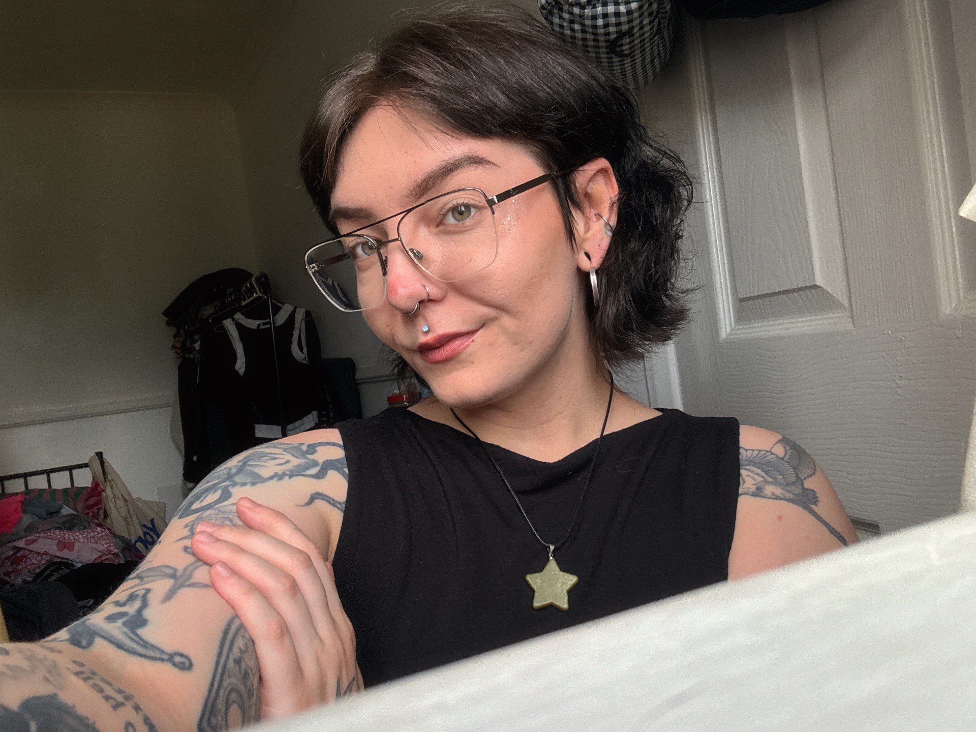 Dee Whitnell taking a selfie at home in their room