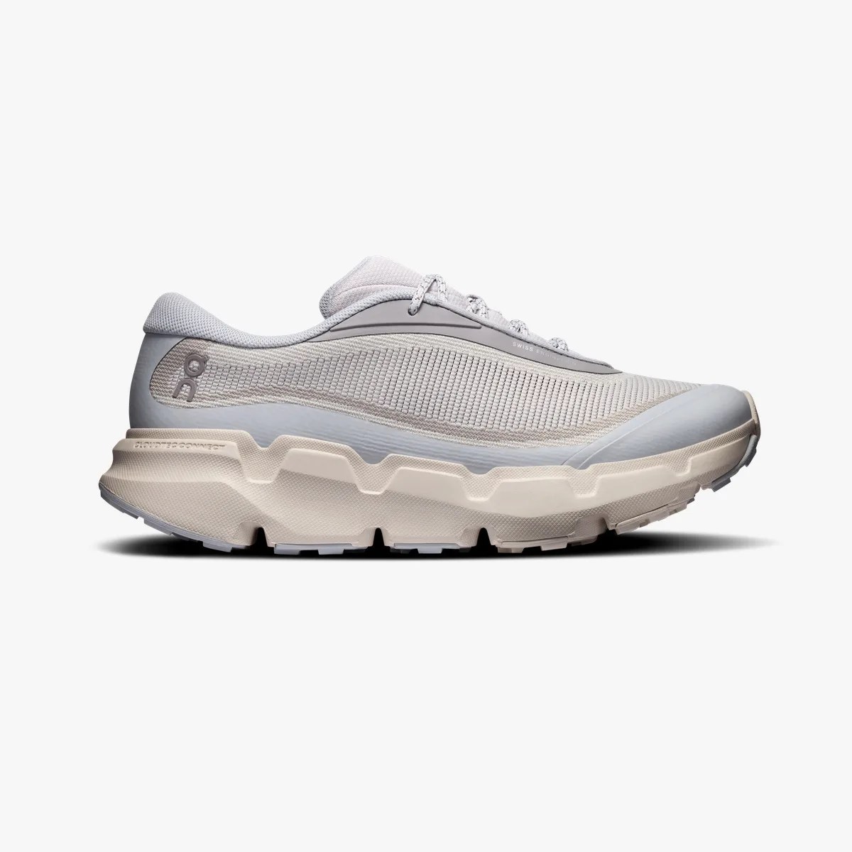 Light gray and beige running shoe with textured mesh upper and thick cushioned sole.