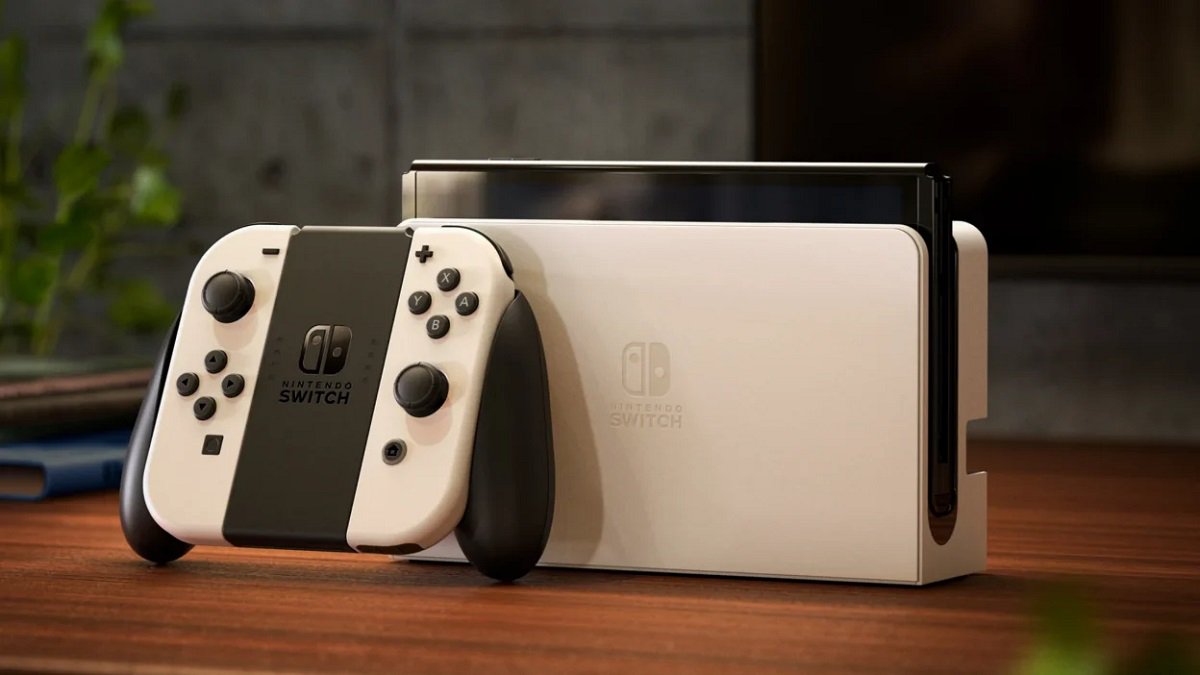 Nintendo Switch OLED model and controller stood on table