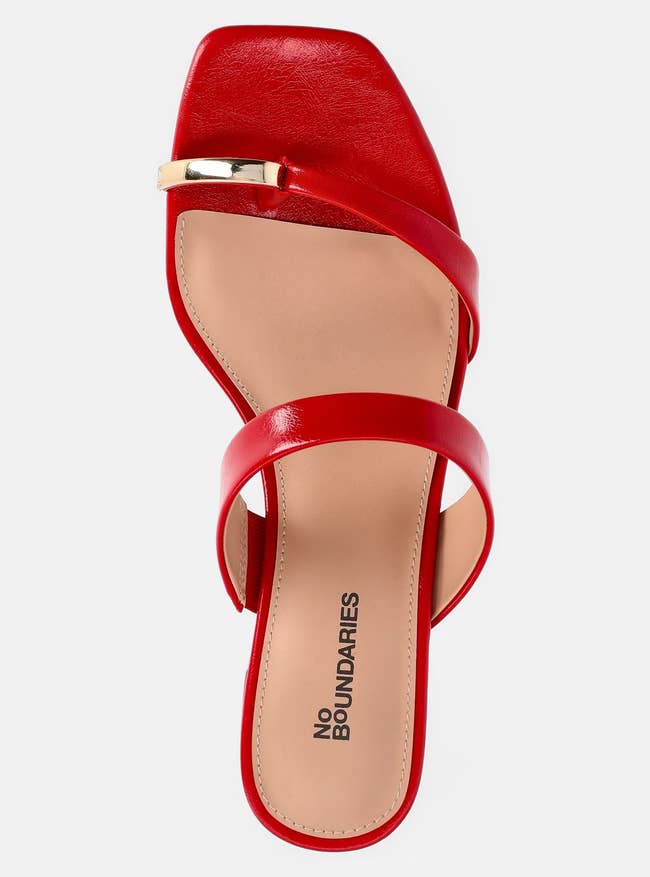 Red slide sandal with two straps and a small gold buckle accent at the toe
