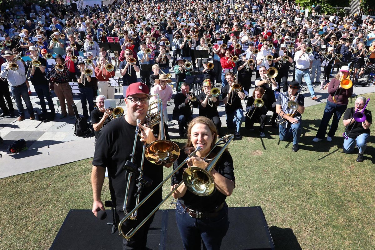 Ipswich City Big Band Music Director Matt Chambers and Ipswich Mayor Teresa Harding lead an ensemble of more than 600 trombone players in an attempt to break a Guinness World Record.