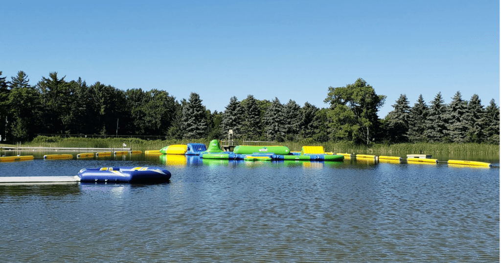 Floating inflatable water park and obstacle course on a lake in Plamann Park in Wisconsin.