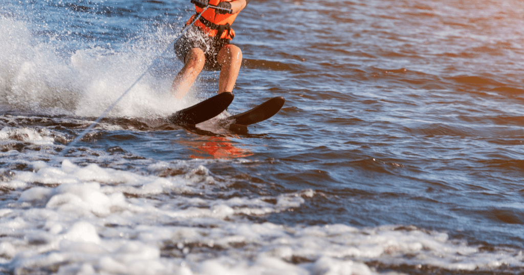 A close-up of a woman water skiing on a lake.