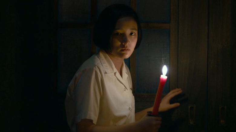 Wei holding a candle in "Detention"
