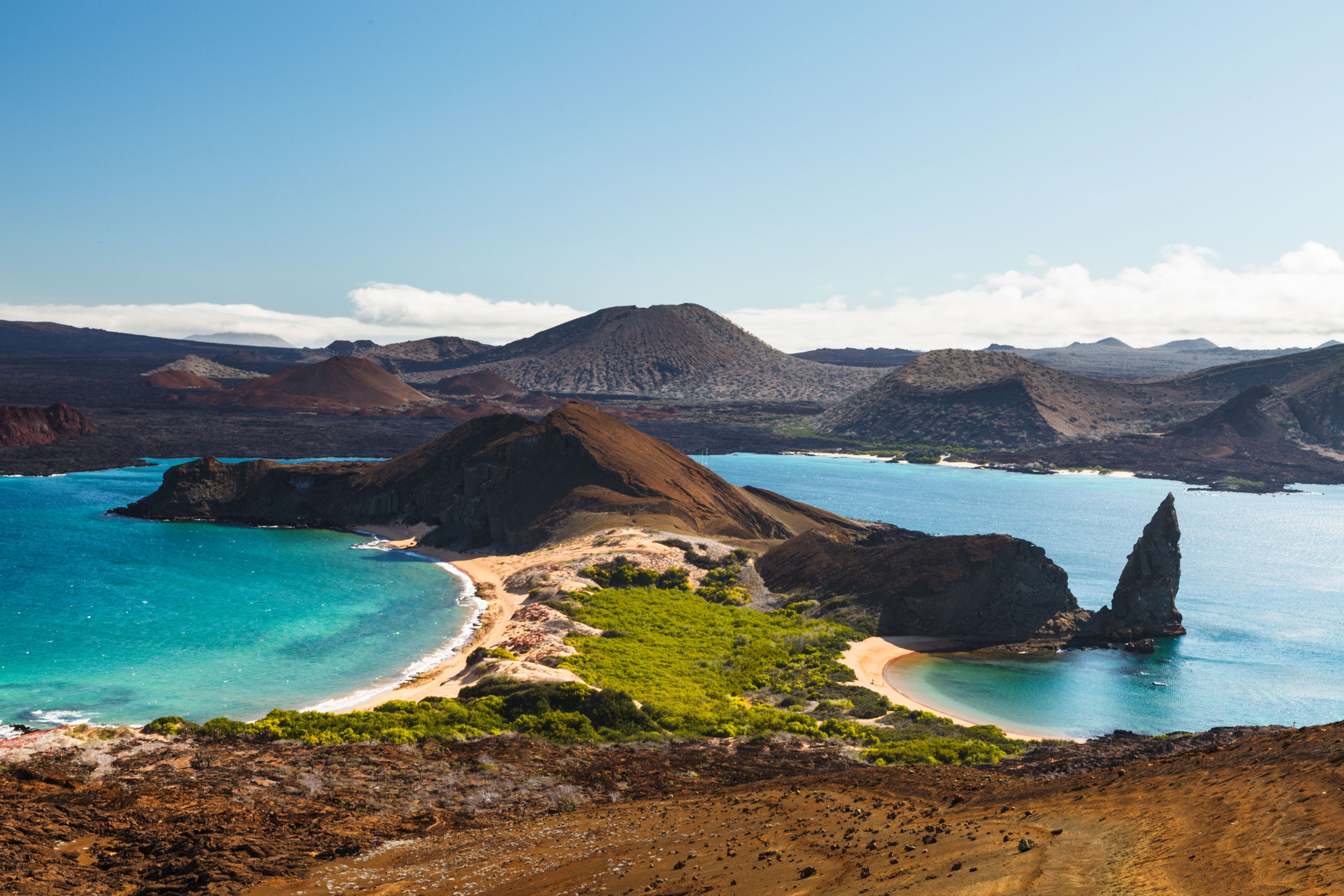 The volcanic landscape of Bartolome Island with famous Pinnacle Rock and Golden Beach