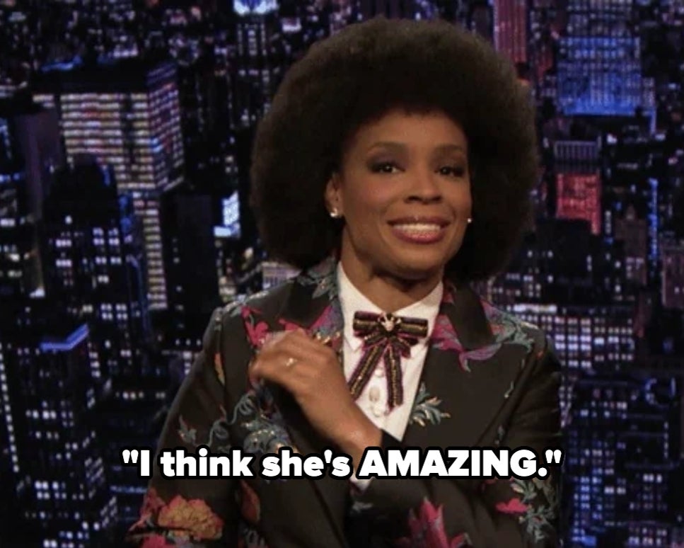 Person in floral suit and bow tie on a talk show, saying
