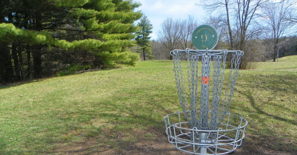 Disc golf basket on hole 9 at the scenic Plamann Park course in Wisconsin.