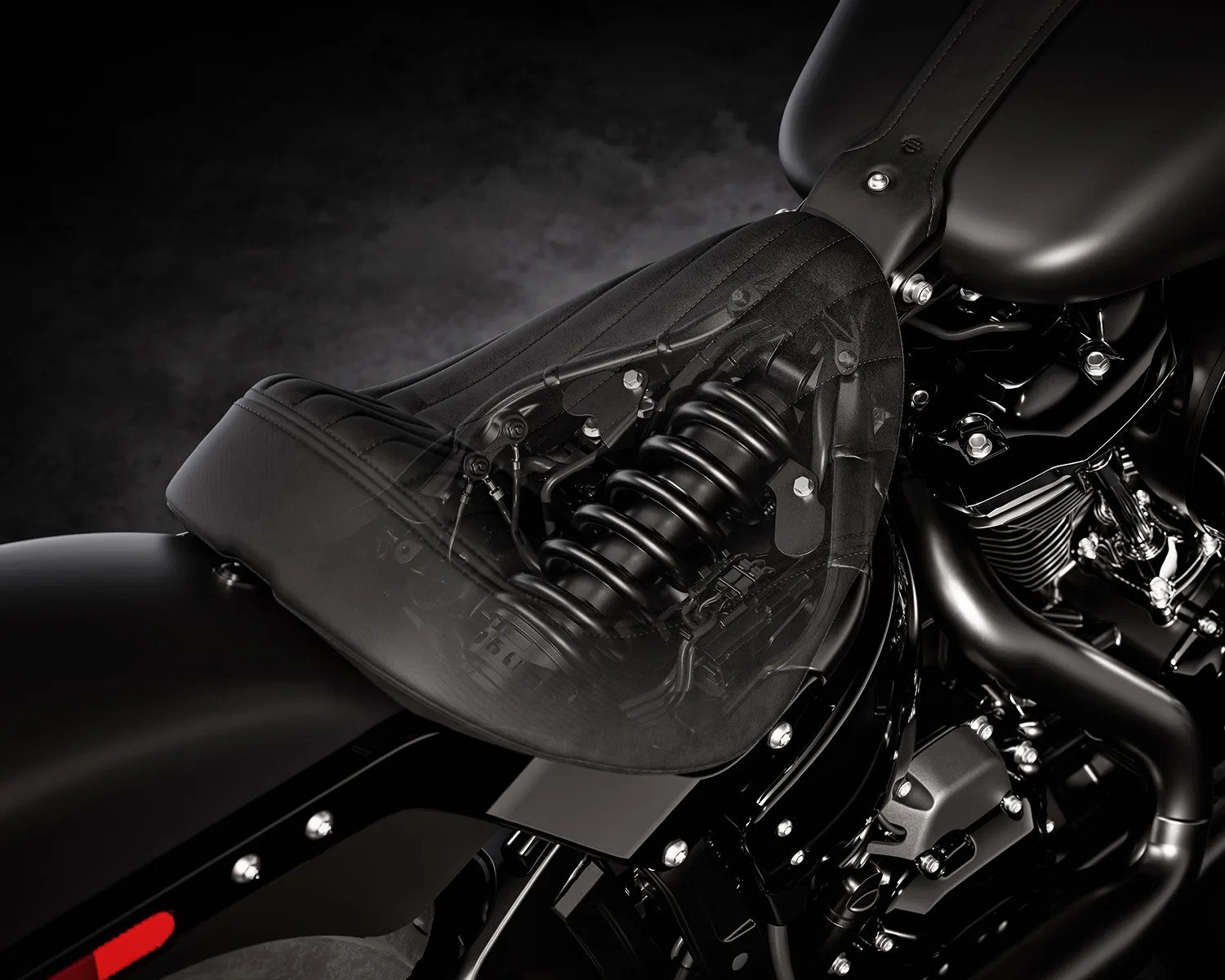 Close-up of a black motorcycle seat with a transparent overlay showing the internal suspension spring mechanism.