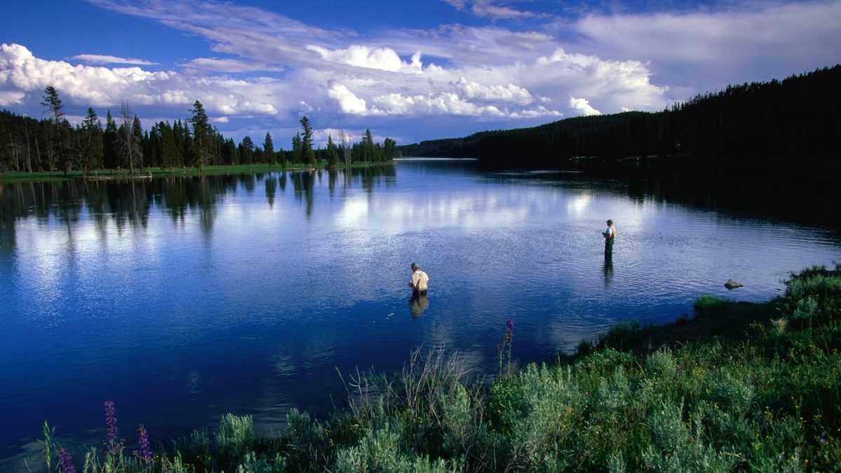 two men flyfishing in the water at Yellowstone National Park