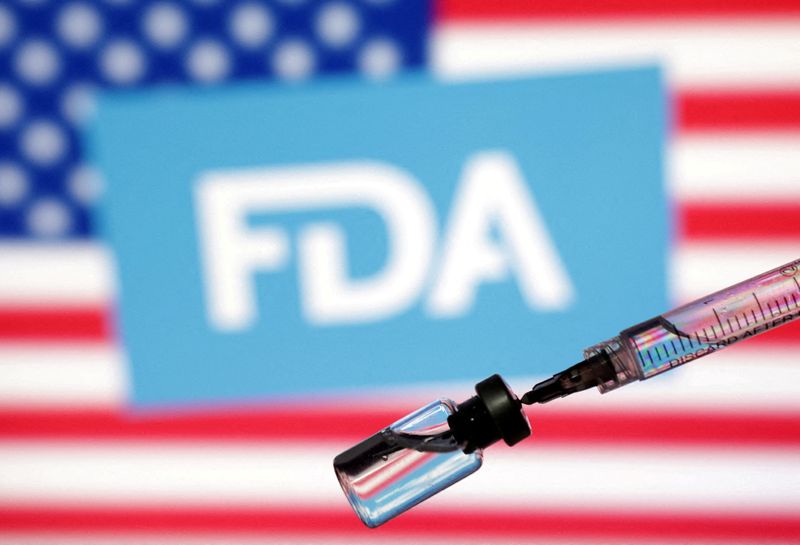 FILE PHOTO: Illustration shows U.S. flag, FDA logo, syringe and vial