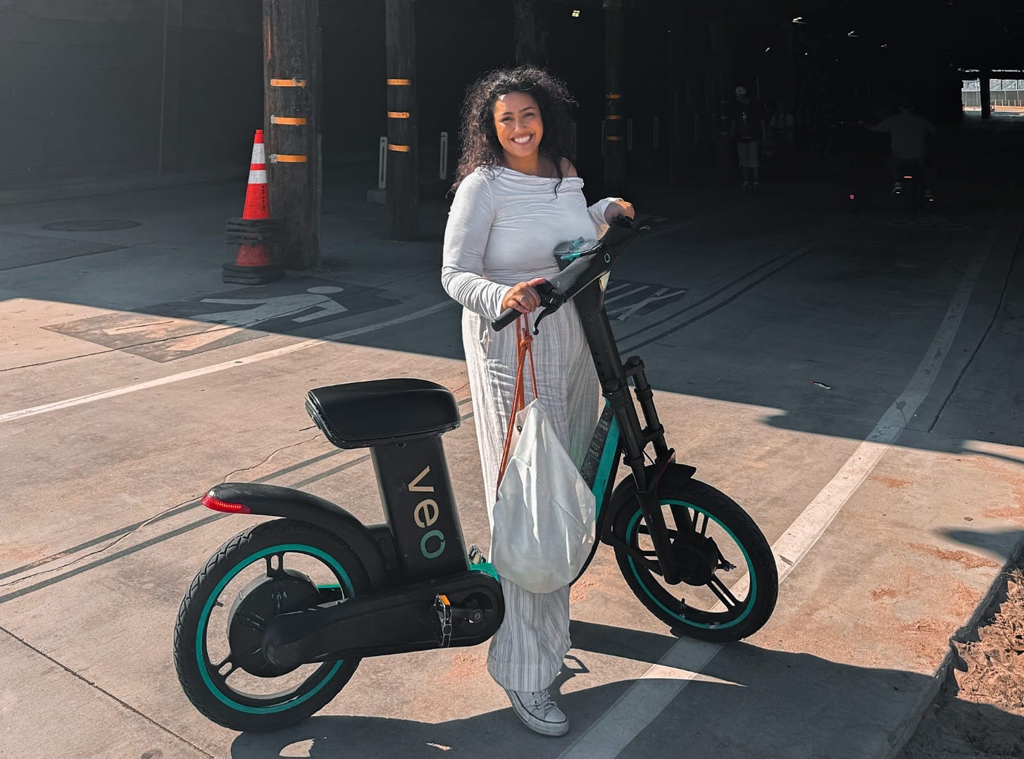 The writer standing with a bike in Venice Beach.