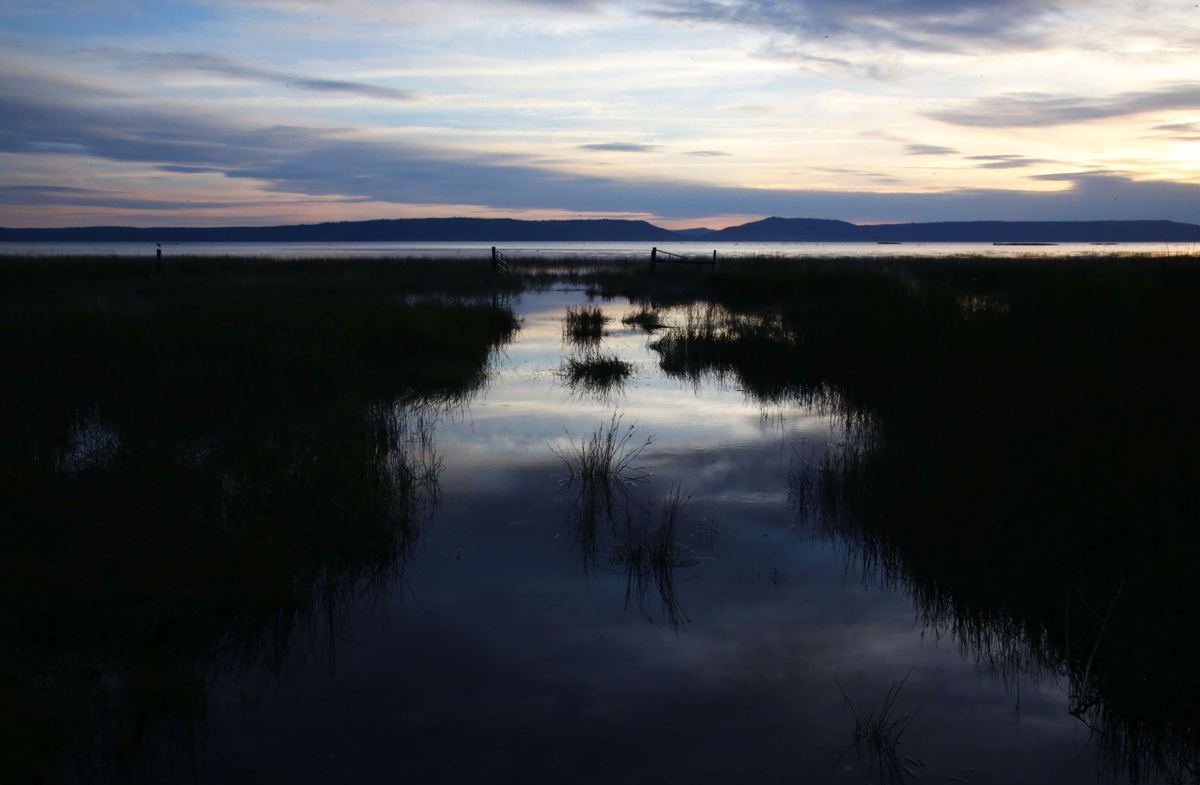 The sun sets over Goose Lake, a 147-square-mile lake that straddles the border of Oregon and California near the southern Oregon town of Lakeview.