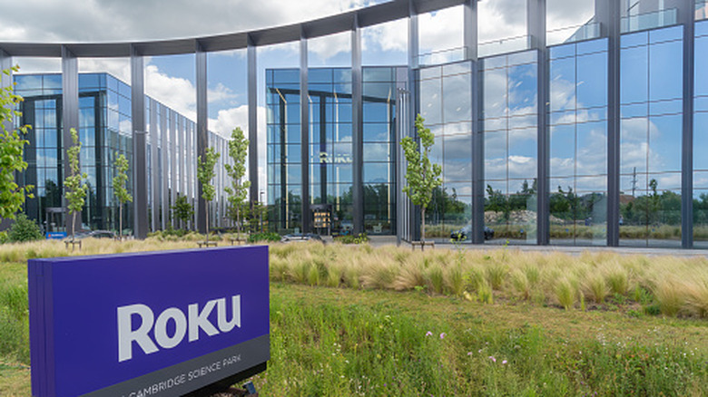 The Cambridge, UK, Roku offices: Two large, reflective buildings with a purple Roku sign in front.