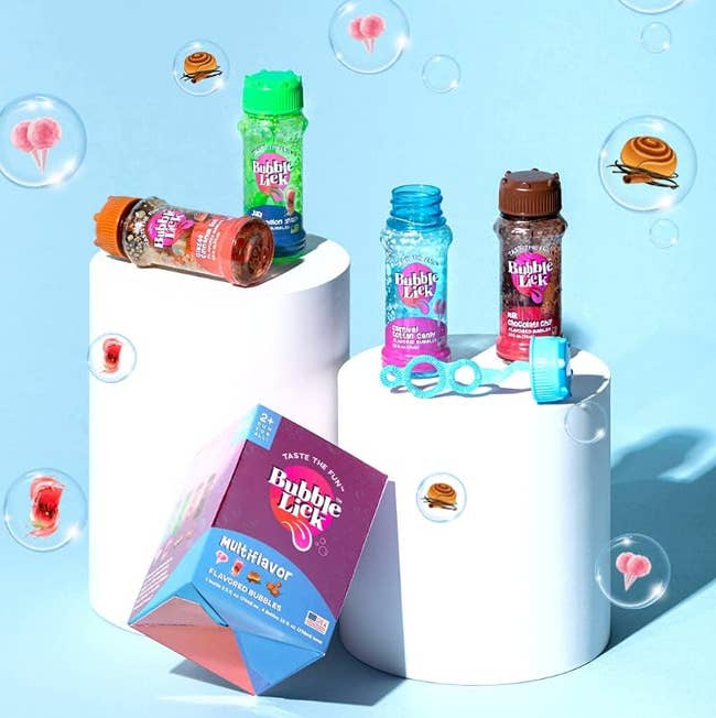 Assortment of flavored bubbles in colorful bottles and packaging, with bubble wand and floating bubbles around them