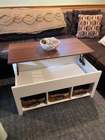 same table with the top lifted to show storage underneath