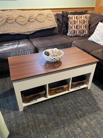 reviewer image white coffee table with a wooden top and a decorative bowl in the center