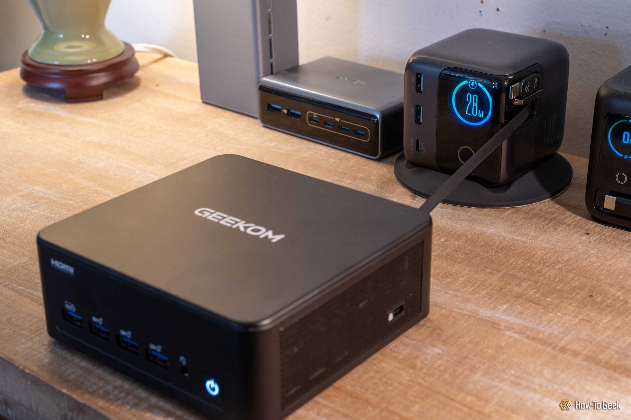 GEEKOM IT13 Max mini PC powered by USB-C charger showing 28W output.