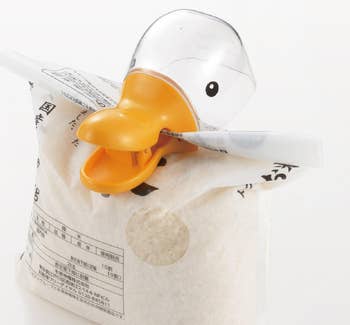 Duck-shaped bag clip on rice bag with Japanese text above that says