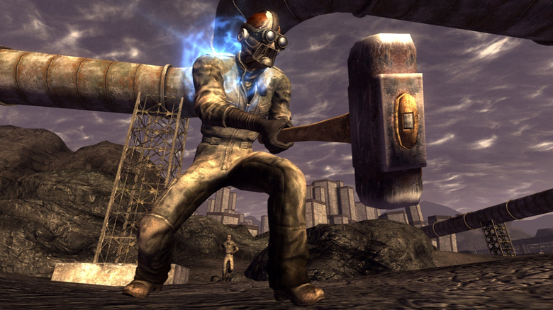 A masked character holds a large hammer by a pipeline in Fallout: New Vegas