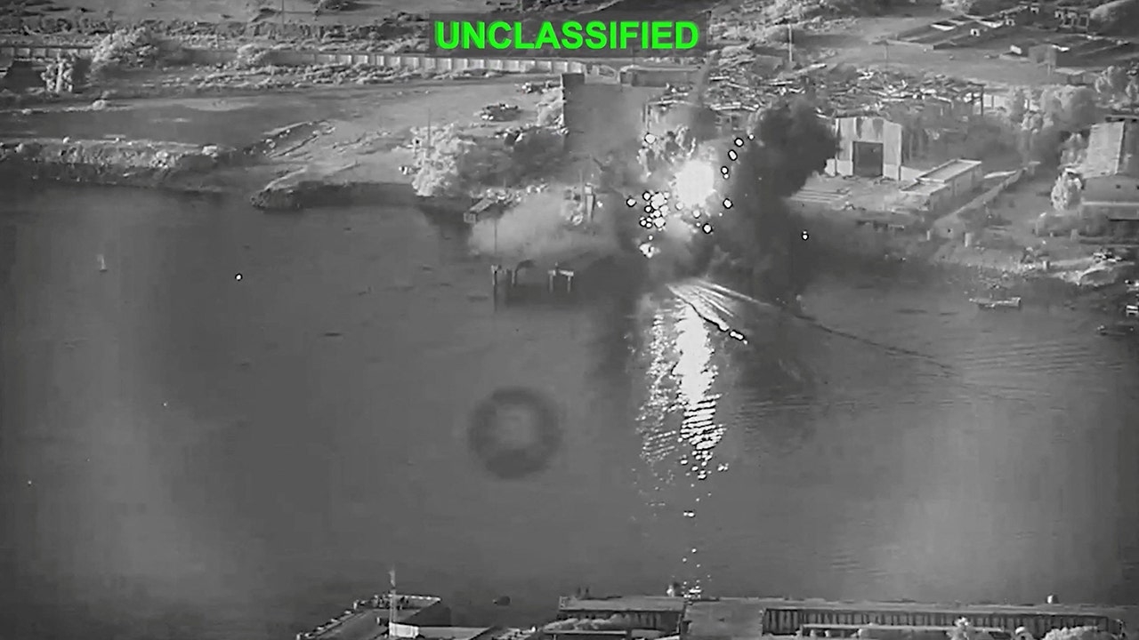Smoke rises after a U.S. one-way attack surface drone reached its target, a submarine and ship maintenance facility, in Bandar Abbas, Iran, according to U.S. Central Command, in this screen grab taken from a video released on July 13, 2026.