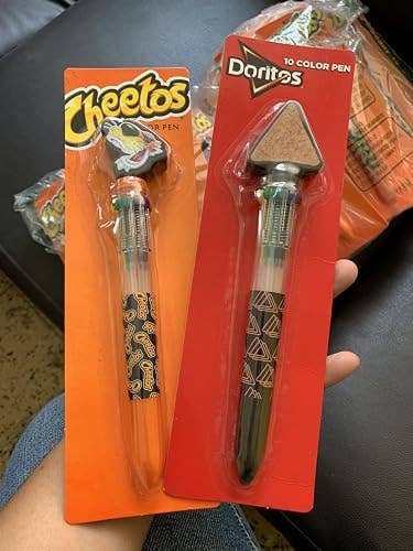 Novelty pens shaped like Cheetos and Doritos snacks, each with different ink colors, in packaging, ideal for fun gifting