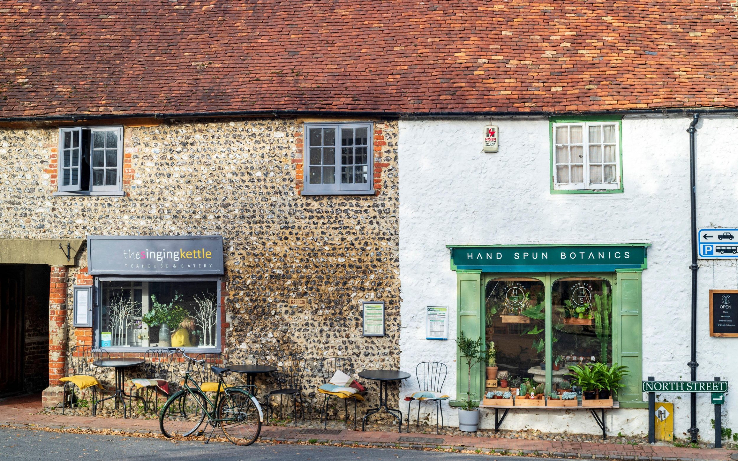North Street in Alfriston by The Singing Kettle tea room and cafe and Hand Spun Botanicals for plants, Sussex UK