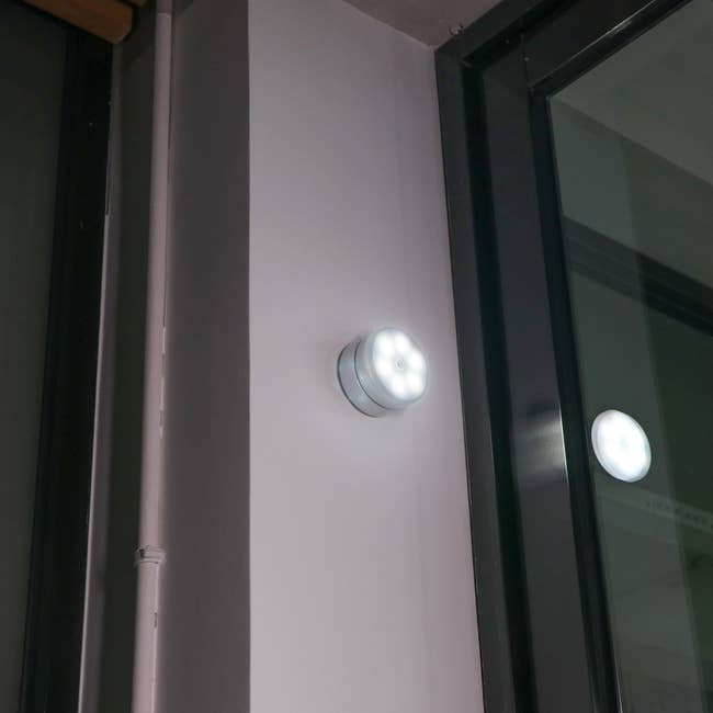 Motion-activated LED light mounted on a wall near a window, ideal for enhancing home security or lighting dark areas automatically