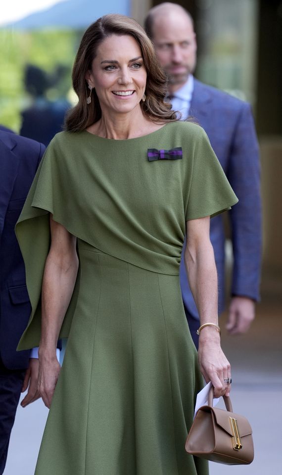 Kate Middleton holding a tan handbag