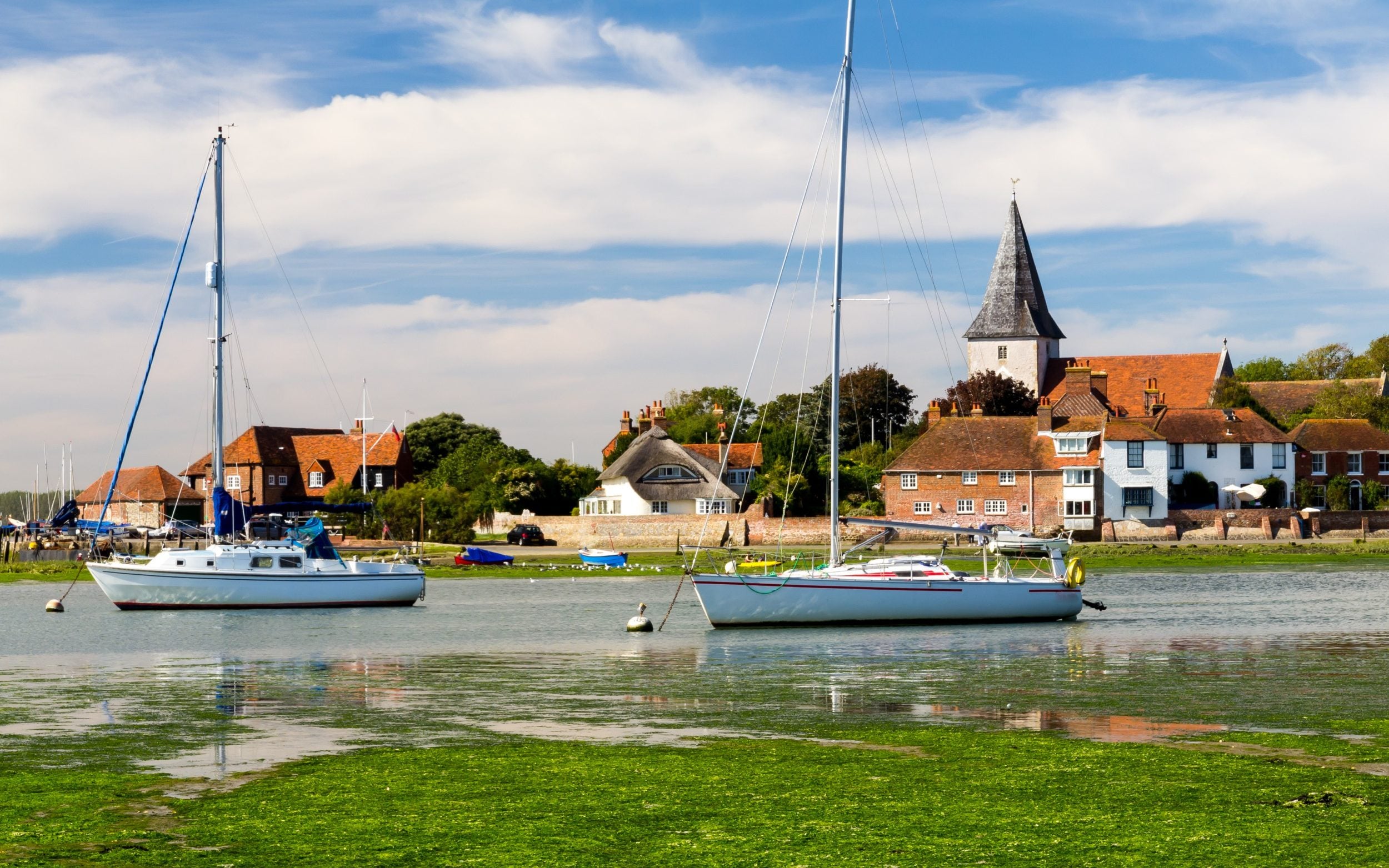 Boats moored at the picturesque village of Bosham West Sussex, England UK