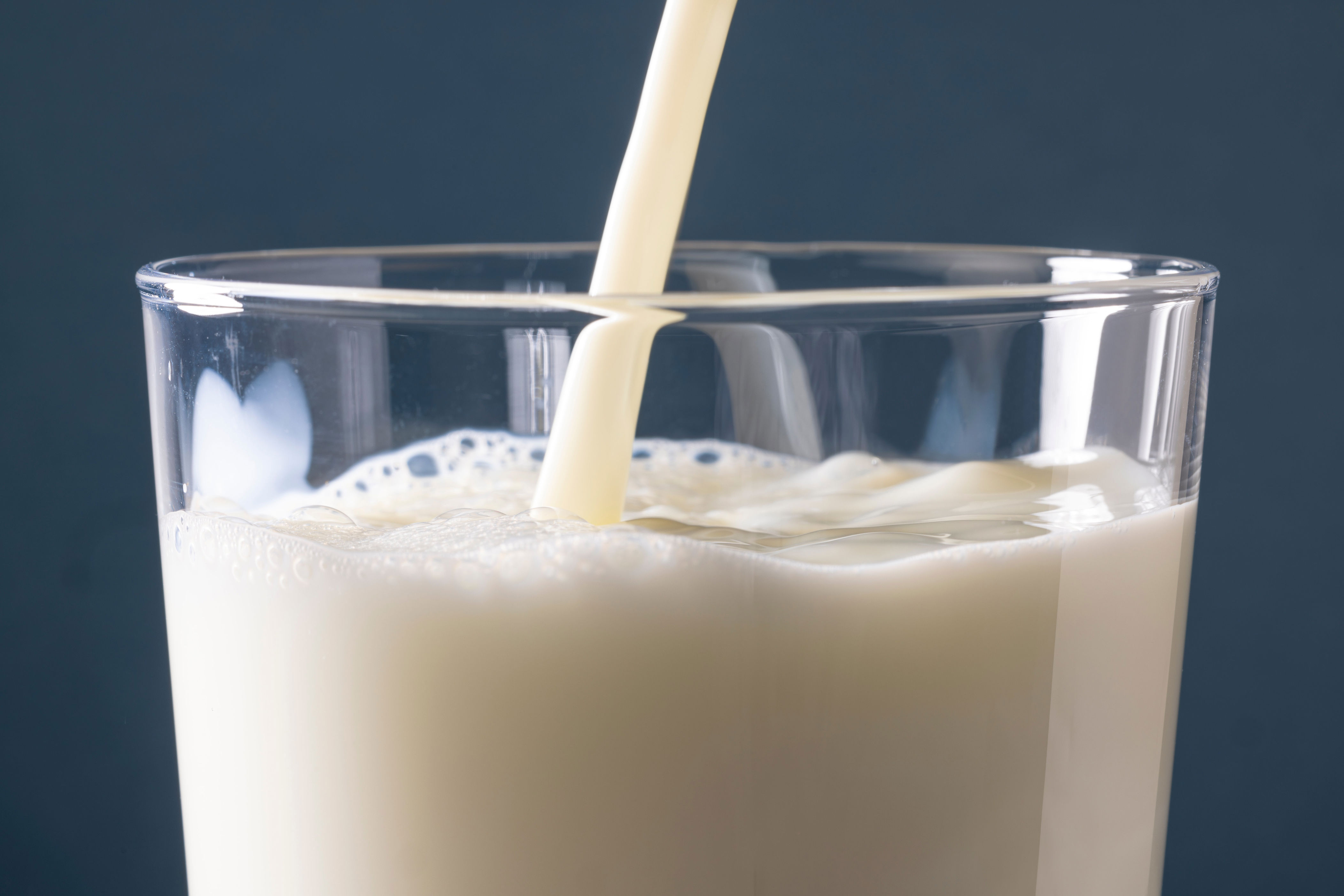 A glass of milk being poured