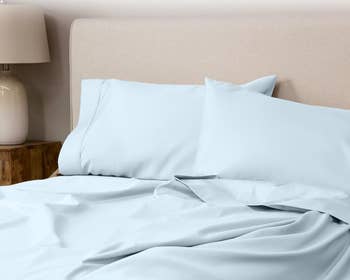 blue bedding set with pillowcases and sheets on a bed