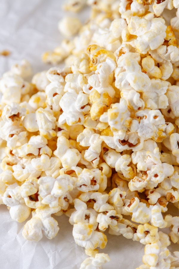 kettle corn spilled out on a white background.
