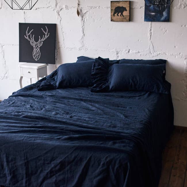 linen sheet set in navy blue on bed