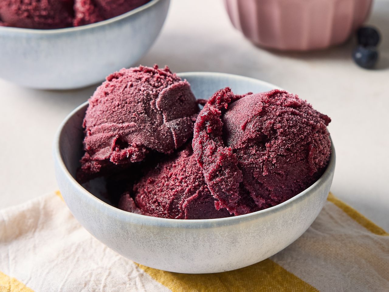 Two scoops of blueberry sorbet in a bowl