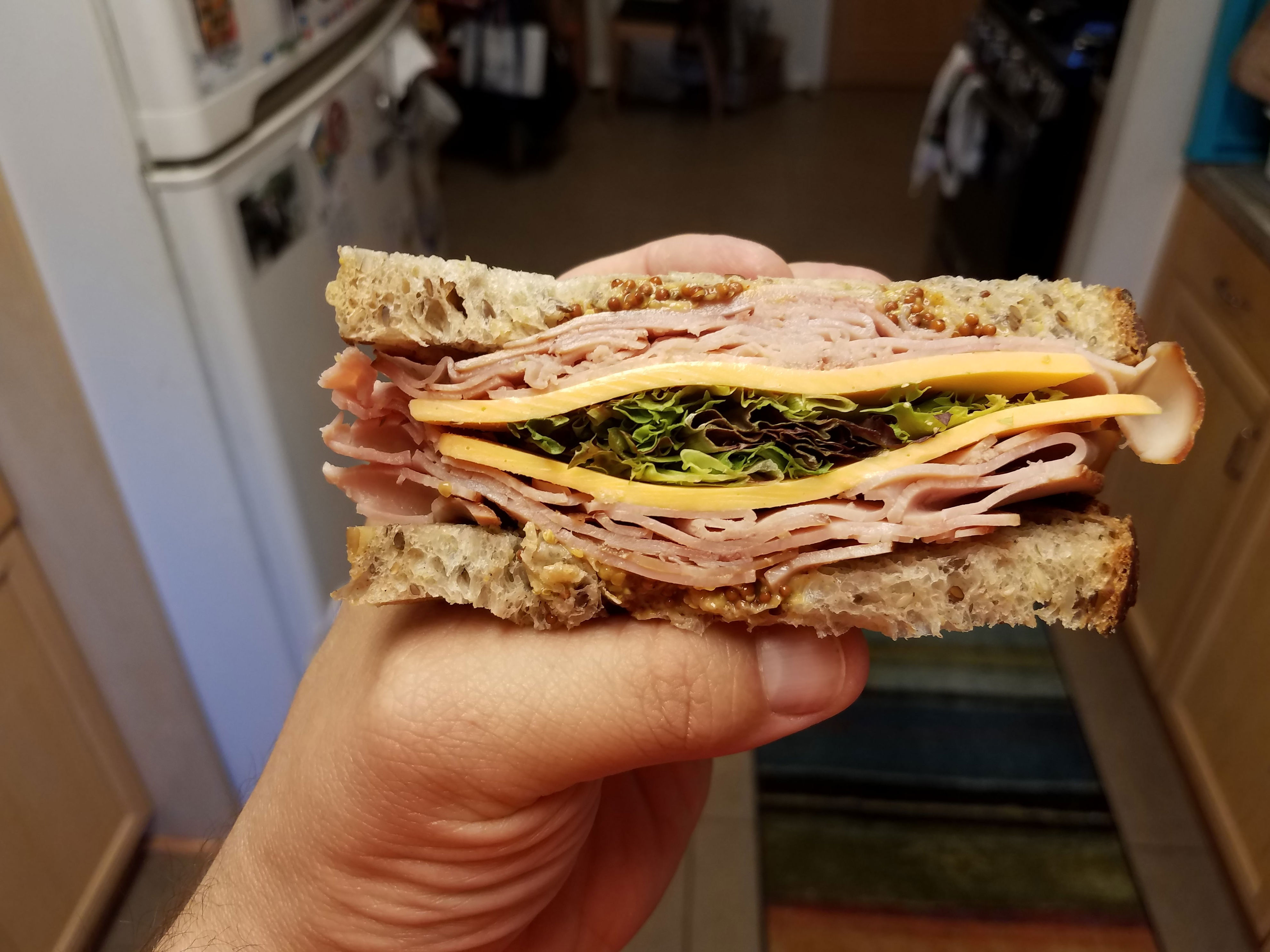 A person holding a deli sandwich