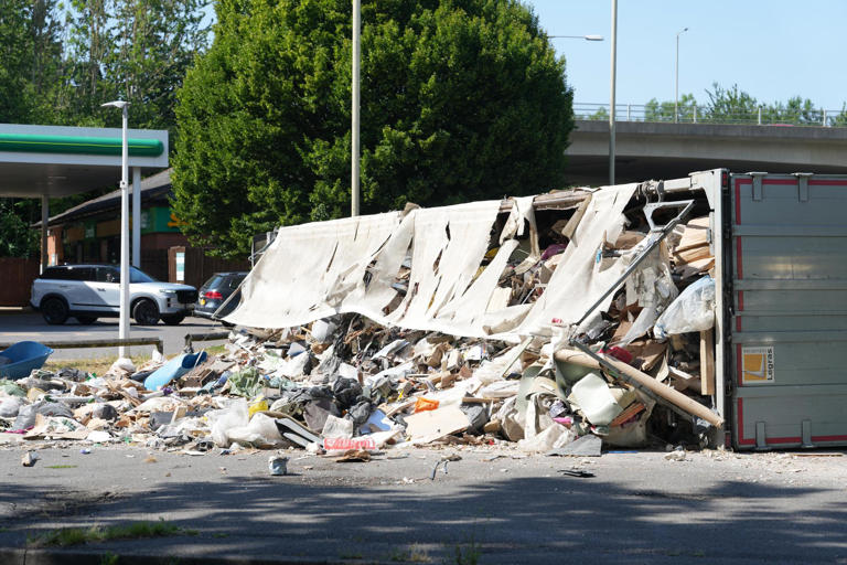 Dramatic images show overturned lorry spilling debris across Sussex A-road
