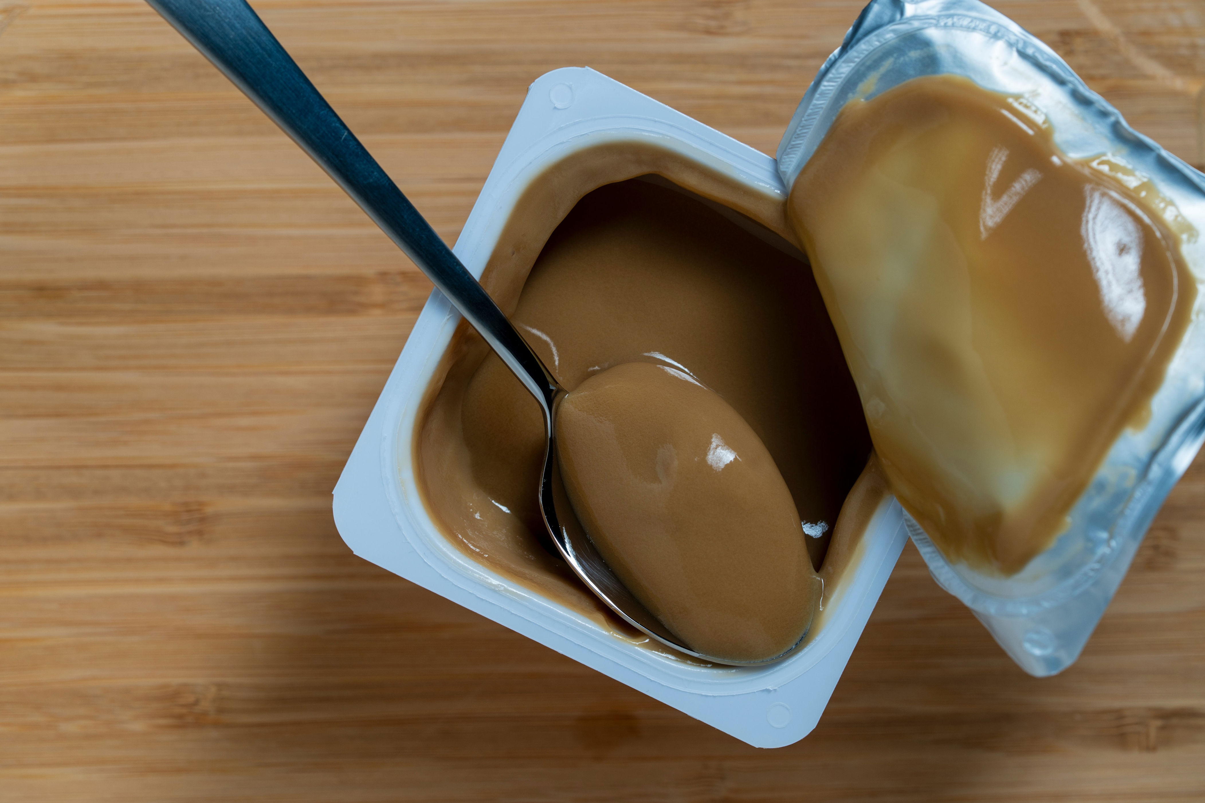A spoon in a pudding cup