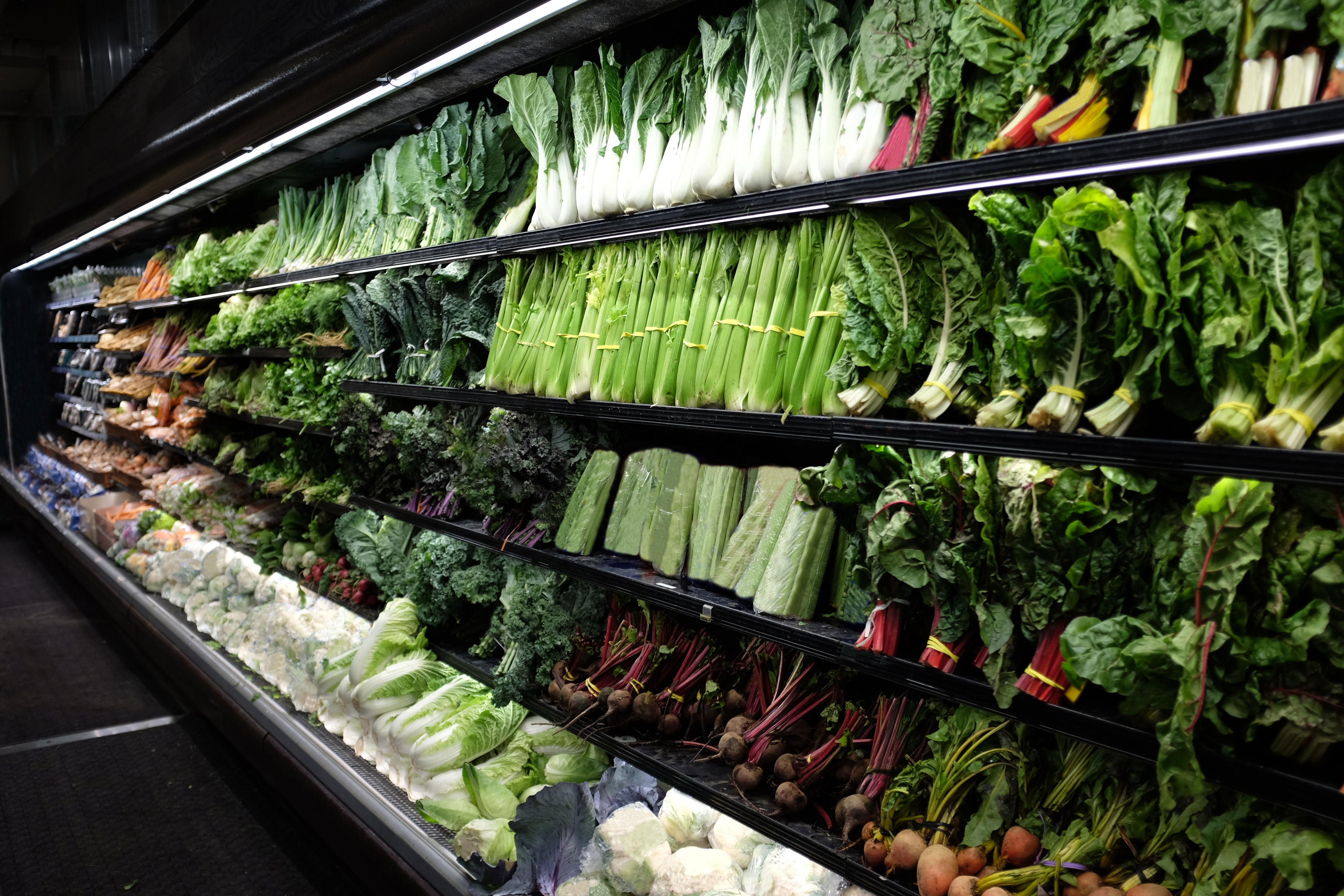 A grocery store display with various produce