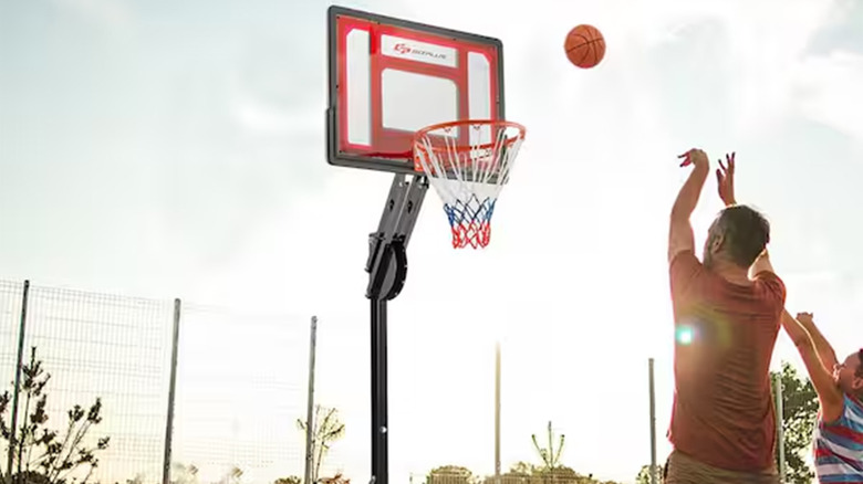 A man shooting a basketball into a hoop.