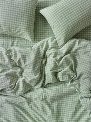 Gingham checkered bed sheets and pillowcases in a relaxing setting, highlighting comfort and style for a cozy bedroom atmosphere