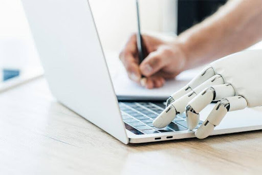 Robot typing on laptop