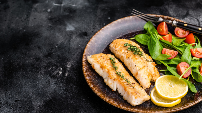 Roasted cod fillets and salad.