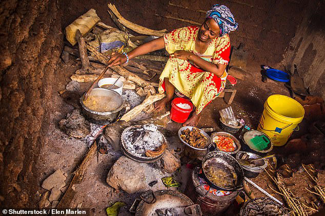 A woman in national clothes cooks a traditional meal in Zanzibar, Tanzania, in March 2018