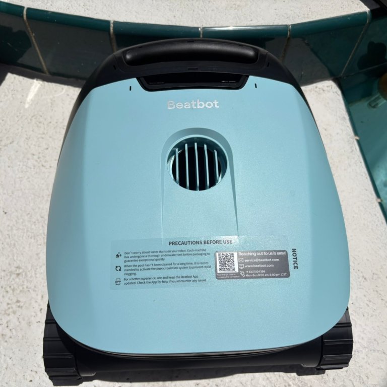 The Beatbot Sora 70 Robotic Pool Cleaner on a pool deck during testing
