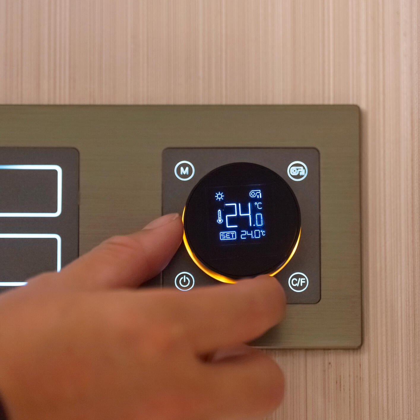Adjusting digital room thermostat by hand