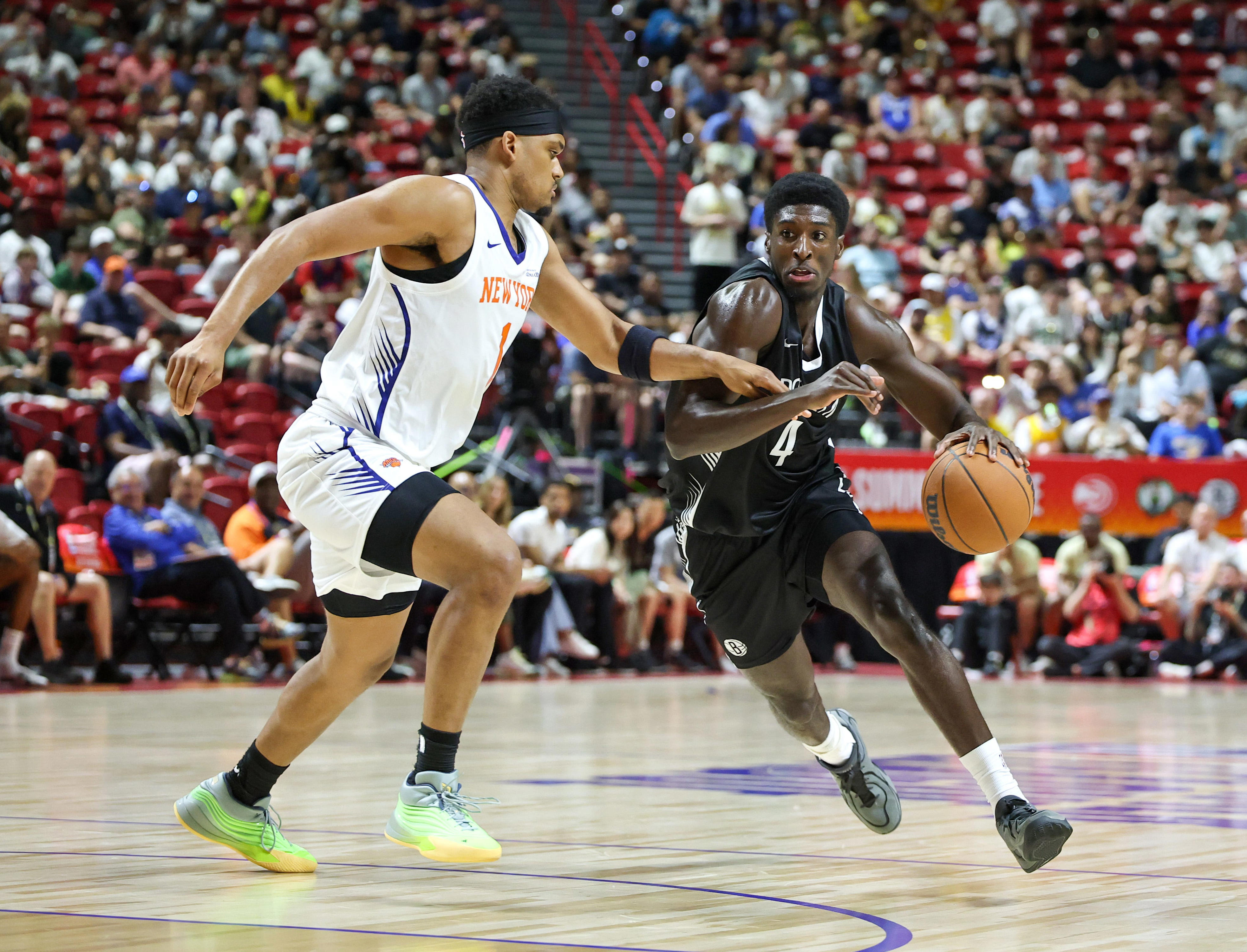 LAS VEGAS, NEVADA - JULY 10: Drake Powell #4 of the Brooklyn Nets drives against Dillon Jones #1 of the New York Knicks in the first half of a 2026 NBA Summer League game at the Thomas & Mack Center on July 10, 2026 in Las Vegas, Nevada. NOTE TO USER: User expressly acknowledges and agrees that, by downloading and or using this photograph, User is consenting to the terms and conditions of the Getty Images License Agreement. (Photo by Ethan Miller/Getty Images)