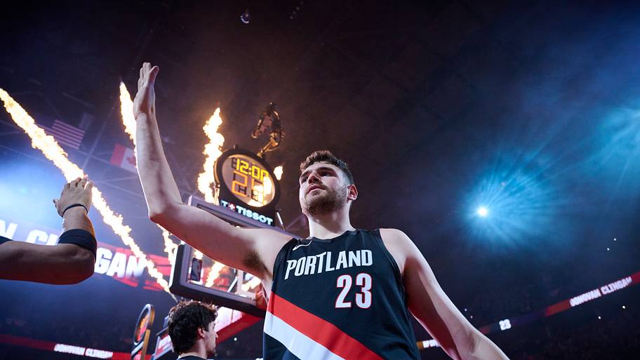 Portland Trail Blazers center Donovan Clingan high fives teammates