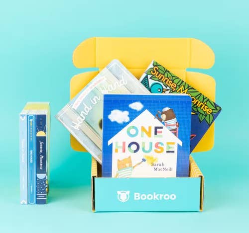 Children's books displayed in an open Bookroo subscription box, designed for gifting and enhancing children's libraries